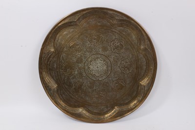 Lot 874 - Two Islamic engraved brass trays