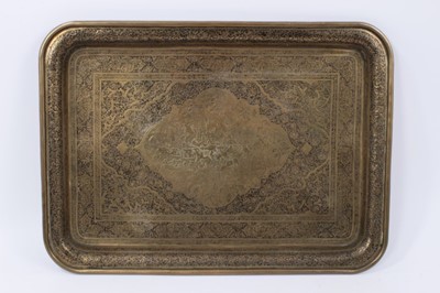 Lot 874 - Two Islamic engraved brass trays