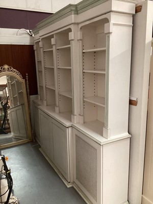 Lot 1132 - Georgian style white and green painted two height breakfront bookcase with adjustable shelves above, two central panelled doors below flanked by two caned doors, 252cm wide, 45.5cm deep, 223cm high