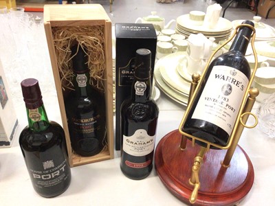 Lot 323 - Four bottles of port to include House of Commons, Cockburn's, Graham's and Warre's 1983 vintage port in a rotating holder