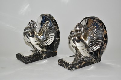 Lot 2406 - A pair of silvered bronze bookends cast from a model by C. Charles, modelled as fan tailed doves on veined marble bases (signed)