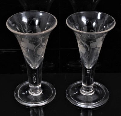 Lot 102 - A pair of Georgian ale glasses engraved with hops and barley, on folded foot