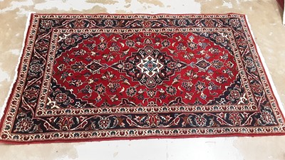 Lot 1137 - Eastern rug with central medallion and floral decoration on red and blue, 164cm x 99cm