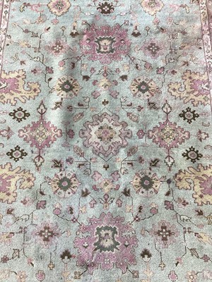 Lot 1140 - Large rug with floral decoration on green ground, 281cm x 188cm