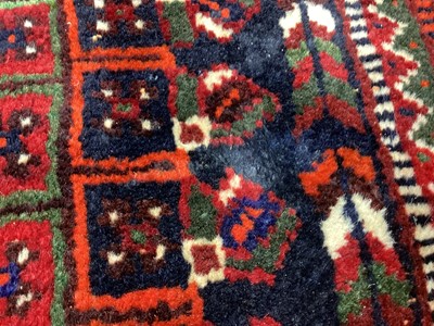 Lot 1142 - Eastern rug with geometric decoration and central medallion on red, blue and cream ground, 250cm x 161cm