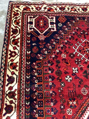 Lot 1142 - Eastern rug with geometric decoration and central medallion on red, blue and cream ground, 250cm x 161cm