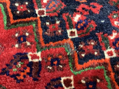 Lot 1142 - Eastern rug with geometric decoration and central medallion on red, blue and cream ground, 250cm x 161cm