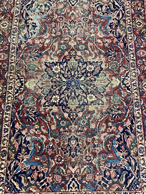 Lot 1143 - Eastern rug with floral decoration on red and blue ground, 200cm x 138cm