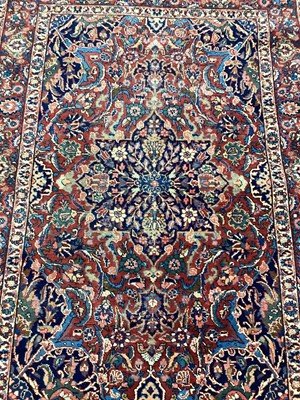 Lot 1144 - Eastern rug with floral decoration on red and blue ground, 192cm x 137cm