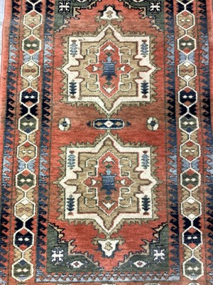 Lot 1145 - Eastern rug with geometric decoration on orange, blue, green and cream ground, 147cm x 84cm