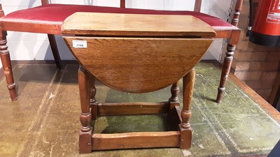 Lot 1149 - Oak oval drop leaf occasional table on turned and block legs joined by stretchers