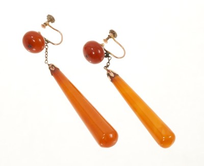 Lot 525 - Pair of antique 9ct gold mounted amber drop screw back earrings