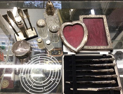 Lot 881 - Group of silver to include two photograph frames, jewellery box, manicure set on stand, glass bottles and other items