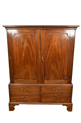 Lot 1352 - George III mahogany linen press, with concave moulded cornice and interior of slides enclosed by pair of panel doors, the base with four short drawers on bracket feet, 127cm wide x 58cm deep x 160c...