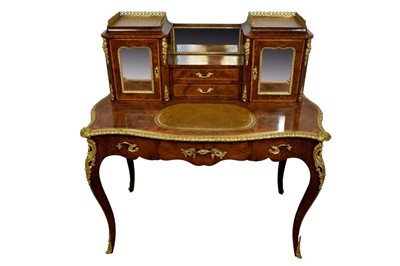 Lot 1367 - Ornate figured walnut and gilt metal mounted bonheur du jour, pierced galleried superstructure and two mirrored cupboard flanking central drawers, leather inset top and serpentine front with frieze...