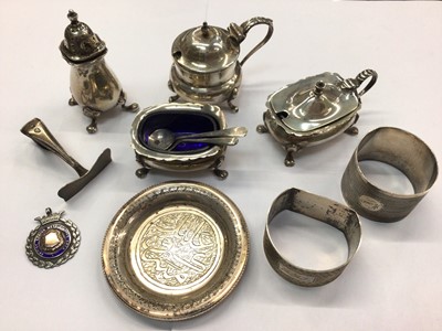 Lot 890 - Four silver cruets/salts, two silver napkin rings, silver pusher, silver fob and a white metal Islamic pin dish