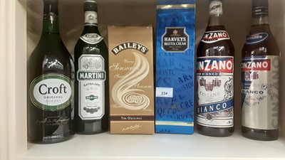 Lot 234 - Eleven bottles of various alcohol to include Harveys Bristol Cream, Baileys, Gilbey's London Dry Gin, Martell Cognac etc