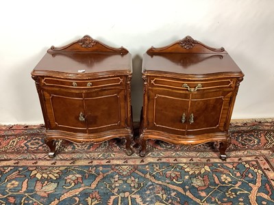 Lot 1168 - Pair of Continental mahogany bedside cupboards of serpentine outline raised on cabriole legs, 61cm wide x 40cm deep x 80cm high