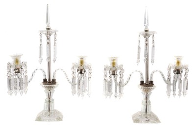 Lot 883 - Impressive pair of Regency style twin branch glass candlesticks, each hung with prismatic glass drops raised on square base, 63cm high