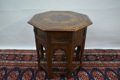 Lot 1442 - Early 20th century teak and metal inlaid Islamic side table, with octagonal top raised on mihrab pierced base, 45cm diameter