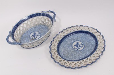 Lot 155 - An English blue and white Pearlware glazed basket and stand, early 19th century, decorated in the classical style, the centre with a roundel containing a sphinx, on a seaweed ground with Greek Key...