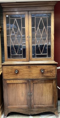 Lot 1017 - George III mahogany and ebony line inlaid secretaire bookcase, the upper section enclosed by pair of astragal glazed door, with fold down secretaire drawer fitted with leather writing surface and i...