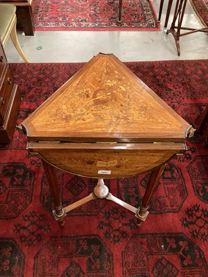 Lot 1447 - Edwardian mahogany, rosewood crossbanded and musical trophy marquetry envelope card table, triangular top with elliptical drop leaves, raised on gilt metal mounted fluted tapered supports with conf...