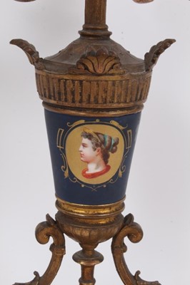Lot 85 - Pair of 19th century Continental gilt metal and painted porcelain four branch candlesticks, with scrolling candle arms and portrait painted vase columns on stepped plinth bases, 50cm high