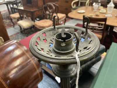 Lot 1453 - Pair of 19th century bronze candlesticks converted for electricity, each with inverted cut glass bowls, raised on flared column with mask swag and stiff leaf ornament, 71cm