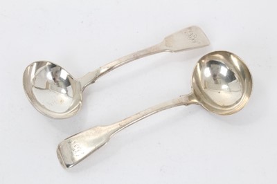 Lot 348 - Pair William IV silver Fiddle pattern sauce ladles, with engraved initials (London 1835)