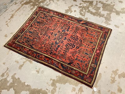 Lot 1506 - Sarouk rug, with angular geometric floral ornament on brick red ground, in main foliate border with signature to top corners, 152 x 114cm