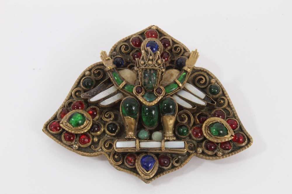 Lot 491 - Antique Indian brooch, believed to represent Garuda, probably Newar People, Kathmandu Valley, Nepal. The multi coloured glass gem stones in gilded brass setting. 53mm x 65mm.