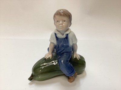 Lot 1116 - Three Royal Copenhagen porcelain figures - boy on marrow number 4539, girl with doll number 1938 and baby number 1517
