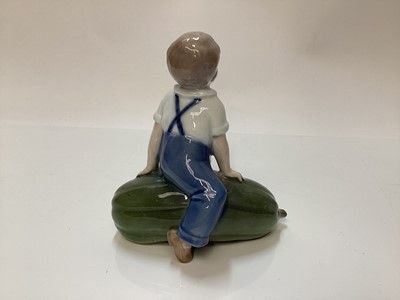 Lot 1116 - Three Royal Copenhagen porcelain figures - boy on marrow number 4539, girl with doll number 1938 and baby number 1517