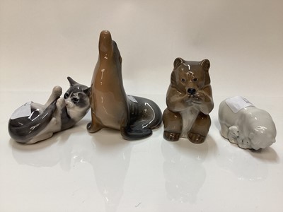 Lot 1117 - Four Royal Copenhagen porcelain models - Bear number 3014, Kitten number 727, Polar Bear group number 4780 and Sea Lion number 1441