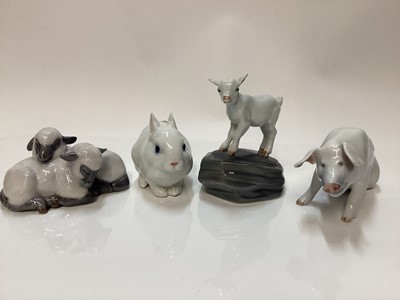 Lot 1119 - Four Royal Copenhagen porcelain models - baby Goat number 4760, Lambs 2769, Pig 1700 and Rabbit 4705