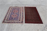 Lot 1214 - Persian rug with two conjoined medallions...