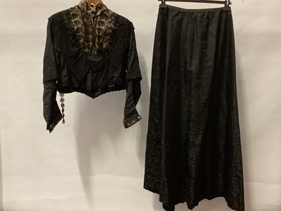 Lot 2055 - Victorian black silk brocade short jacket with embroidered net lace front and stand up collat, other lace insets and two tier sleeves.  Plus a matching skirt.