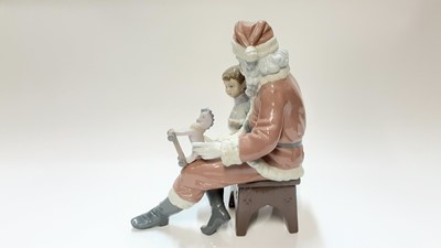 Lot 1181 - Lladro porcelain figure group - Santa Claus and young boy