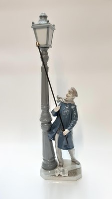 Lot 1182 - Lladro porcelain figure of a man lighting street lamp, 47.5cm high