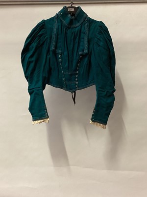 Lot 2057 - c1890's cropped wool boned jacket with full leg of mutton sleeves and militarty influenced braid trim, open back with tie fastenings and bobbin lace to cuffs. Plus Victorian light weight soft cotto...