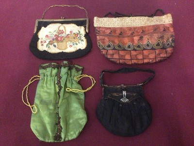 Lot 2063 - Green satin Reticule purse with square bead trim, Indian silk floss embroidered drawstring bag, petit point purse and one other, detachable lace dress front, black sequin and heavily bead capelet,...