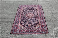 Lot 1222 - Kashan rug, the navy foliate field within...