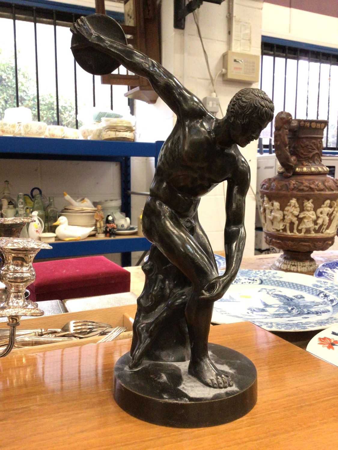 Lot 111 - A Grand Tour style bronzed figure of a discus thrower, on a circular base