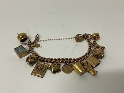 Lot 100 - 9ct gold charm bracelet with heart shaped padlock clasp and twelve gold and yellow metal charms.