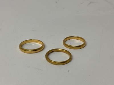 Lot 103 - Three 22ct gold wedding bands, ring sizes J 1/2, K and M1/2 (3)