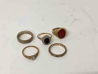 Lot 107 - Five 9ct gold rings to include a diamond single stone ring, sapphire and diamond cluster ring, signet ring, and two eternity rings (5)