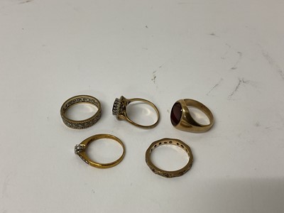 Lot 107 - Five 9ct gold rings to include a diamond single stone ring, sapphire and diamond cluster ring, signet ring, and two eternity rings (5)