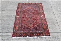 Lot 1227 - Eastern rug centred by three conjoined lozenge...