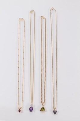 Lot 454 - Four gold and diamond and gem-set pendants on 9ct gold chains